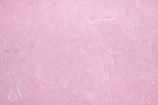 Handmade art paper pink color or mulberry paper texture as background.