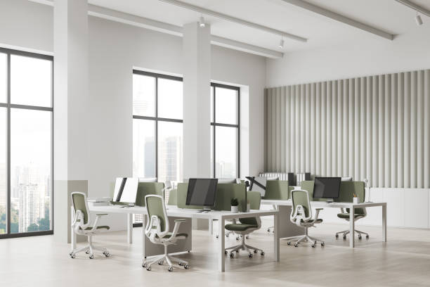 istock Stylish workspace interior with pc desktop and table in row near window 1751410781