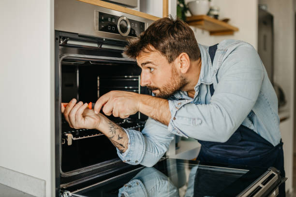 istock Experienced male handyman seamlessly integrating a new oven into a kitchen setup, ensuring seamless functionality and efficient use for homeowners 1751456529