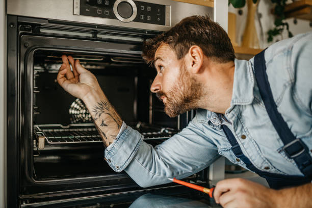 istock Diligent carpenter expertly handling an oven repair project, equipped with specialized tools and a keen eye for identifying and resolving technical issues 1751456530