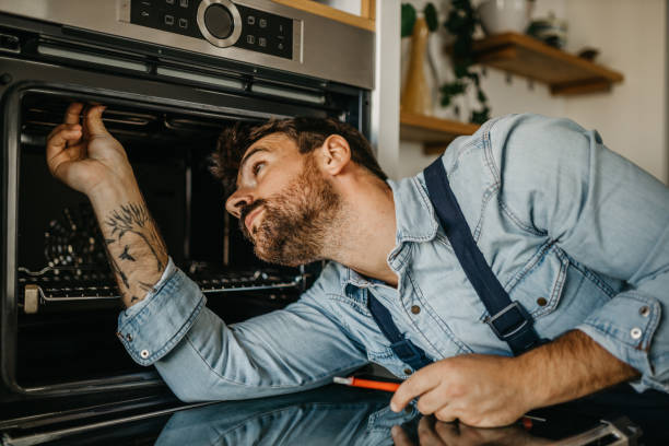 istock Diligent carpenter expertly handling an oven repair project, equipped with specialized tools and a keen eye for identifying and resolving technical issues 1751456679