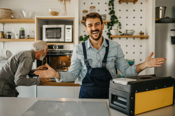 istock Expert handyman adeptly utilizing his tools to fix and install oven for a senior customer, displaying exceptional skill and dedication in his craft 1751459836
