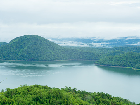 Srinakarin Dam (Khwae Yai River) with mist and cloud over lake water in the morning, Kanchanaburi Thailand