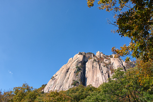 This is a picture of Sinheungsa Temple (Seoraksan) (신흥사(설악산) in Seoraksan National Park, Gangwon, South Korea. A Buddhist temple in the misty mountains.