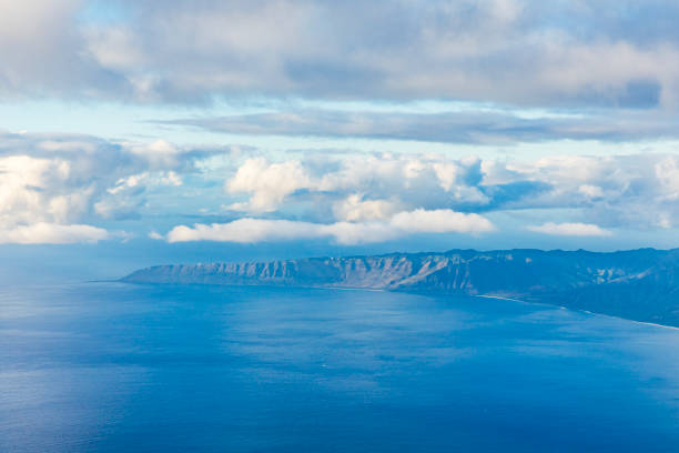 istock Clouds above the ocean with an island 1751499927
