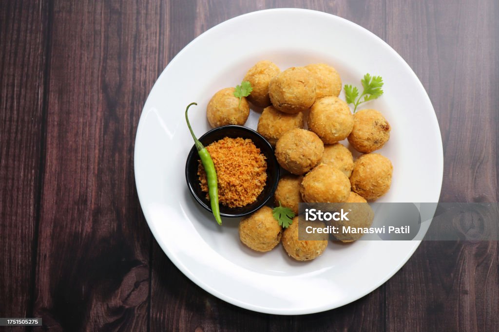 Dry Kachori is a deep fried crispy and crunchy balls of maida flour, stuffed with spicy mix of gram flour, sev, Lentils, Tamarind chutney and other Indian spices. A popular tea time snack. Copy Space Asia Stock Photo