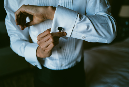 Asian Man Putting on Tuxedo for Events