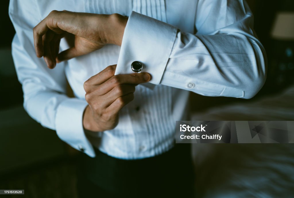 Asian Man Putting on Tuxedo for Events Necktie Stock Photo