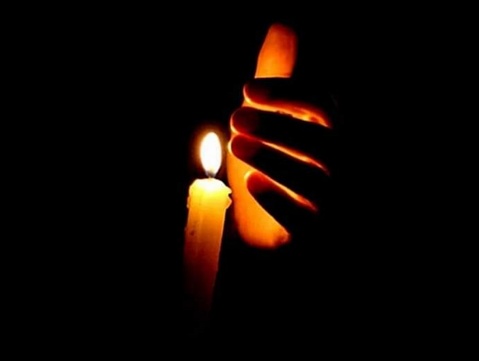 The black background has an orange candle and the flame of a white candle and a five-fingered hand protecting the candlelight from the wind.