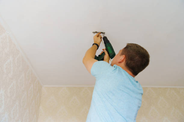 istock A man is working on the installation of a ceiling luminaire on the ceiling. 1751548398
