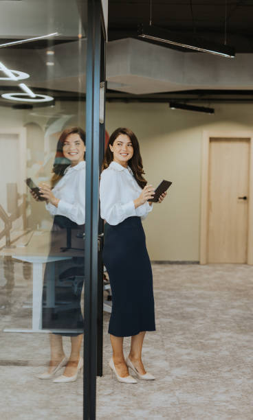 istock Young woman with digital tablet standing in the modern office 1751561342