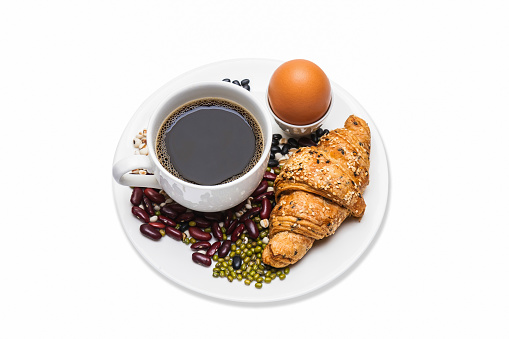 Homemade croissants and black coffee on white background