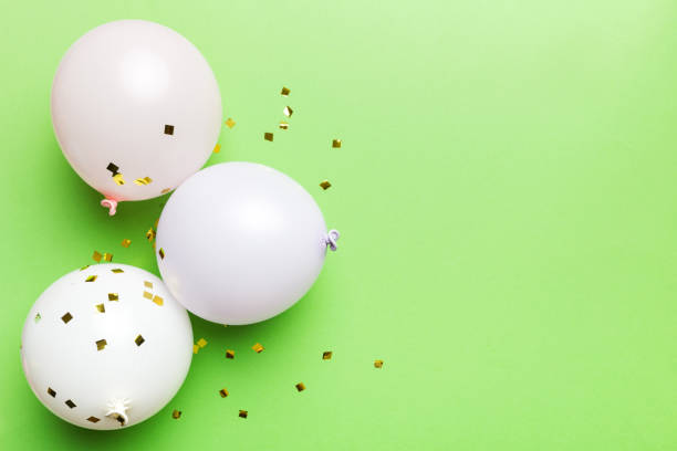 istock Background with fastive air balloons of round shape and confetti, multicoloured top view. Birthday party background 1751572842
