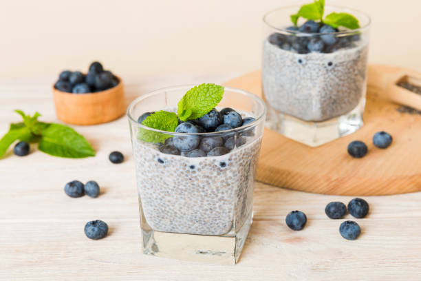 istock Healthy breakfast or morning with chia seeds vanilla pudding and blueberry berries on table background, vegetarian food, diet and health concept. Chia pudding with coconut milk and blueberry 1751573389