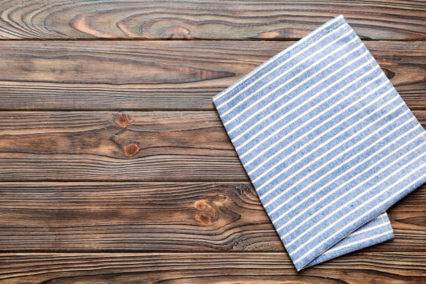 istock top view with blue kitchen napkin isolated on table background. Folded cloth for mockup with copy space, Flat lay. Minimal style 1751573391