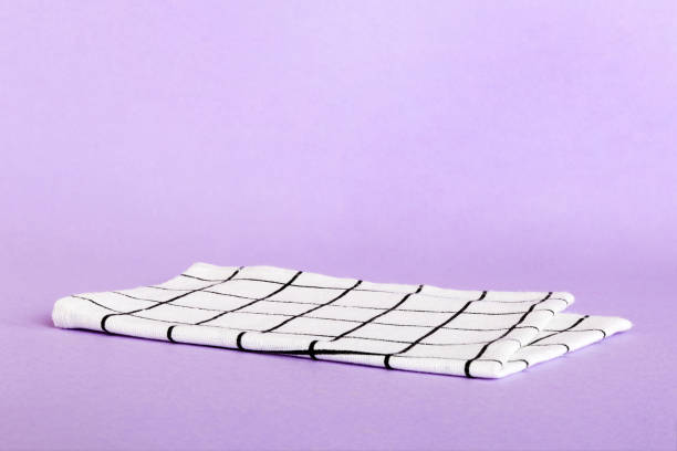 istock top view with white empty kitchen napkin isolated on table background. Folded cloth for mockup with copy space, Flat lay. Minimal style 1751573393