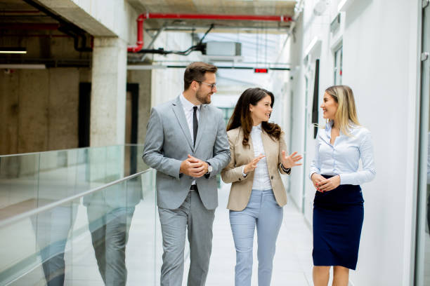istock Young startup team have a discussion while walking in the modern office corridor 1751576212