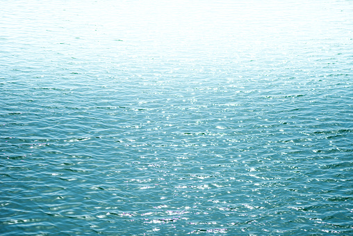 Blue sea surface with waves reflection aqua perspective background