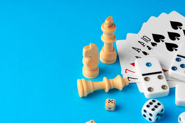 istock Items for playing chess, poker and domino on blue background studio shot 1751604579
