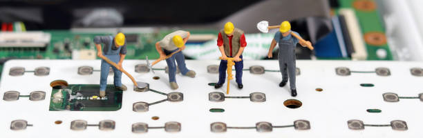 istock The miniature repairs the board. 1751607297