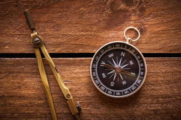 istock Vintage drawing and navigational Compass on a rustic wooden board 1751612285