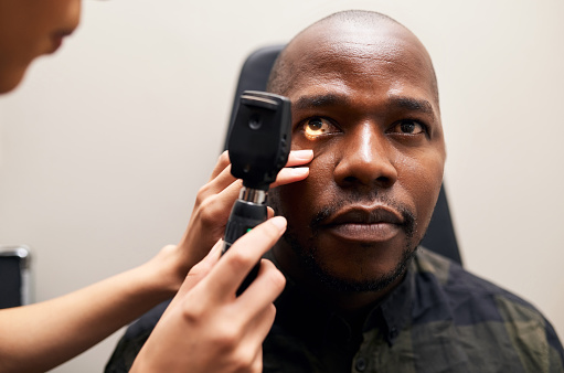 Eye exam, tool and black man with doctor, optometrist and vision microscope for healthcare. Ophthalmology, test and woman check patient for optical glaucoma with medical equipment in clinic or office