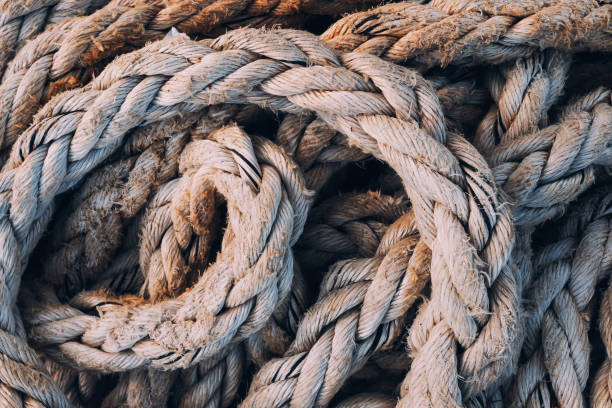 istock Old worn frayed ship ropes as background 1751632223