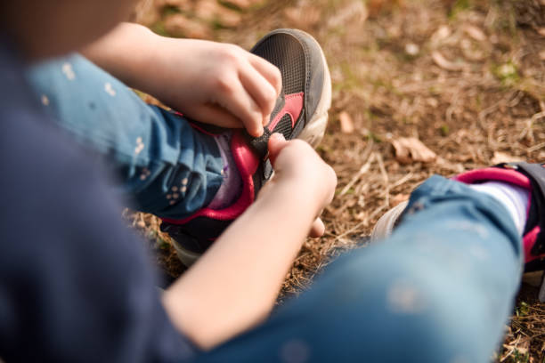 istock A child puts on sneakers while sitting outside 1751639747
