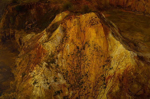 An aerial view of golden rock formations in a mine.