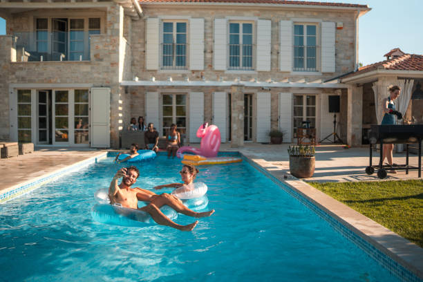 istock Diverse Couple Taking Selfie on Floaties at Villa Party 1751652107