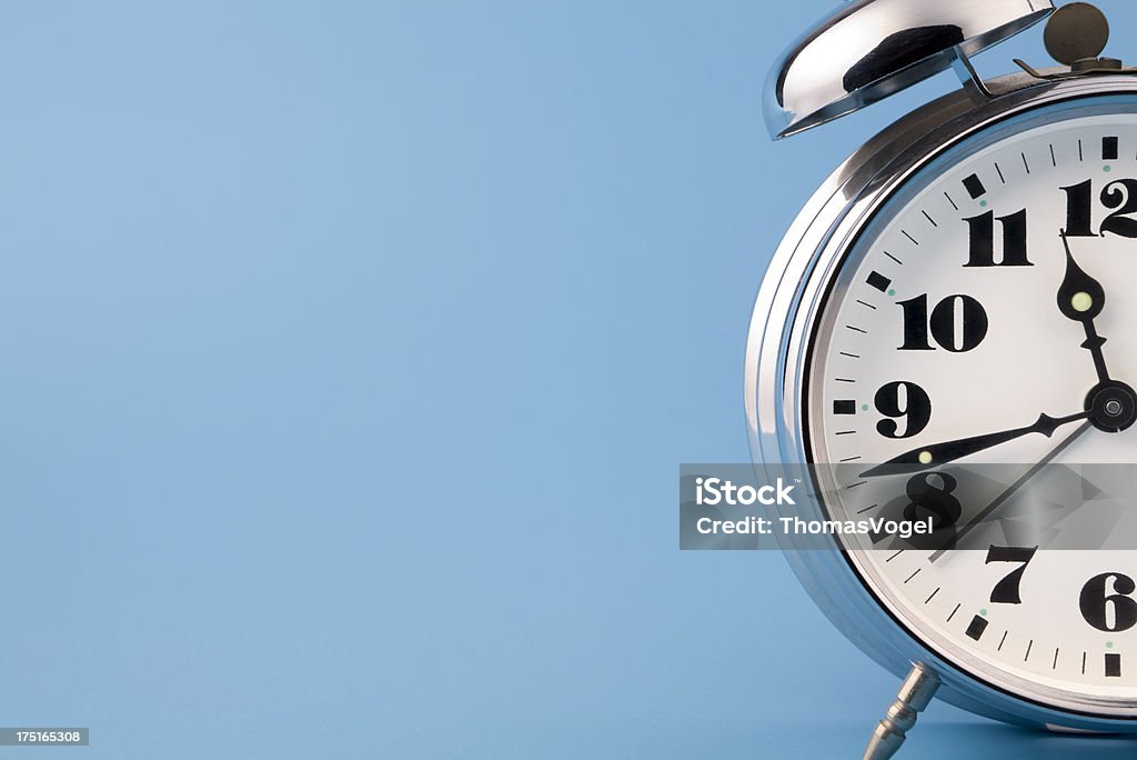 Retro alarm clock Retro chrome alarm clock detail on blue background. No sharpering. Clock Stock Photo