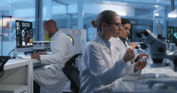 Science laboratory, research woman and team work on healthcare innovation, development or investigation. Lab people, coworking group and scientist assessment, problem solving or pharmaceutical study