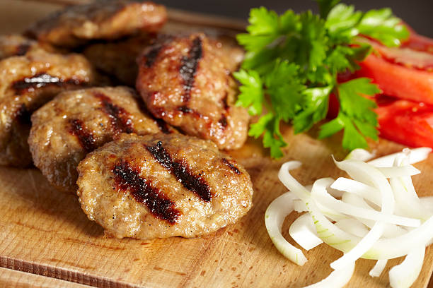 Meatballs Meatballs served with onion,tomato and parsley cooked selective focus indoors studio shot stock pictures, royalty-free photos & images