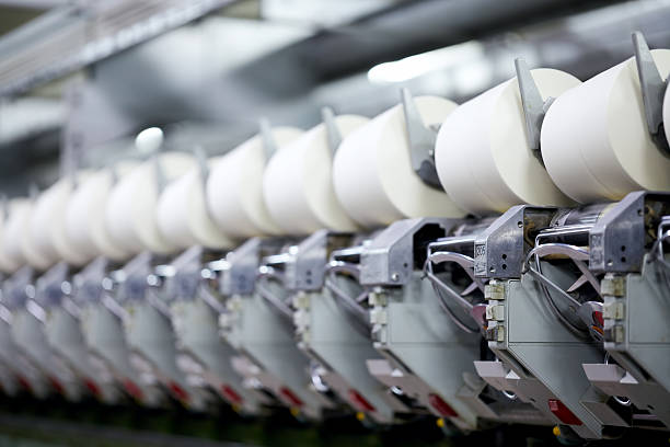 Yarn spinning machine Yarn spinning machine in a modern textile factory. Very shallow depth of field. textile industry textile thread industry stock pictures, royalty-free photos & images