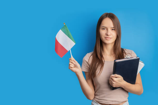 istock student with italian flag on blue background, language learning, immigration, foreign education, work abroad, copy space 1751667312