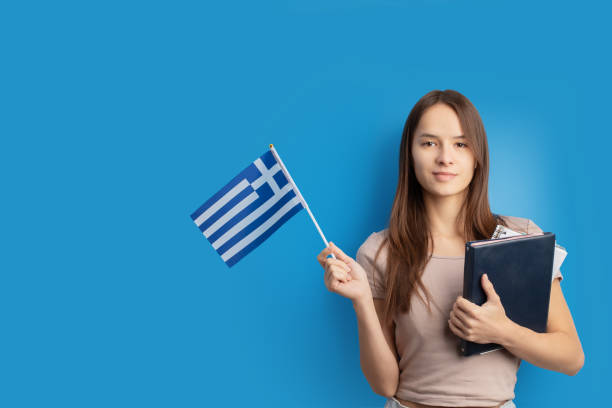 istock student with Greek flag on blue background, language learning, immigration, foreign education, work abroad, copy space 1751667318