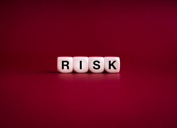 istock Word RISK on white cube blocks isolated on dark red background, minimal style. Management and control, financial crisis, bankruptcy, loss investment economic recession sales risk concepts. 1751675304