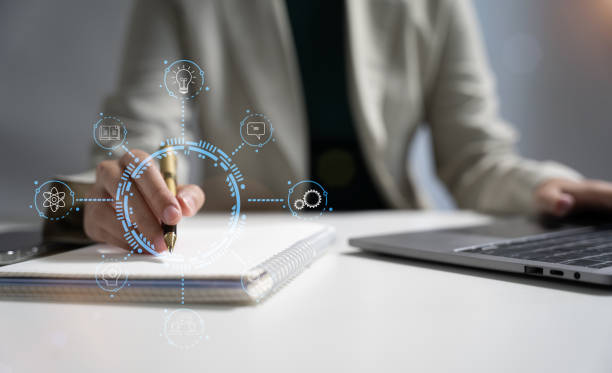 istock Elearning online working concept. Business woman working on laptop computer, searching and taking note on paper notebook with pen working in office. 1751682839