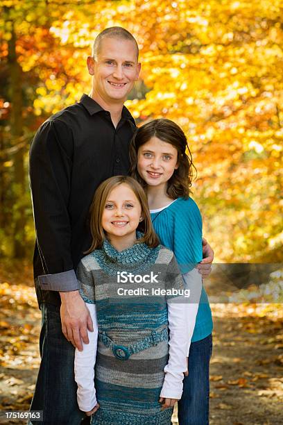 Portrait Of Dad And Two Daughters With Colorful Fall Woods Stock Photo - Download Image Now