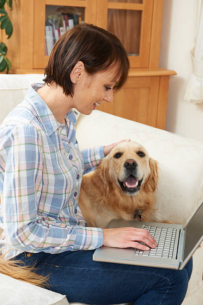 istock Dog Sitting Next To Owner Using Laptop 175169818