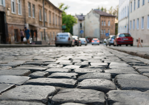 Close-up of glistening paving stones on an ancient street in the evening. Background is out of focus