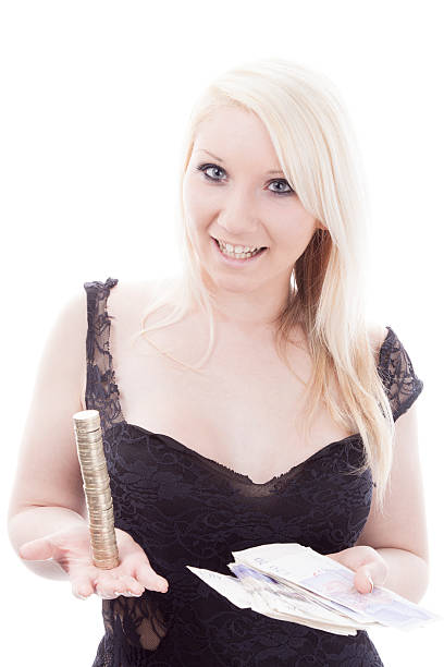 Pretty Blonde Balancing Coins "A happy blonde balancing the books - well, a pile of pound coins. Isolated on white." twenty pound note stock pictures, royalty-free photos & images