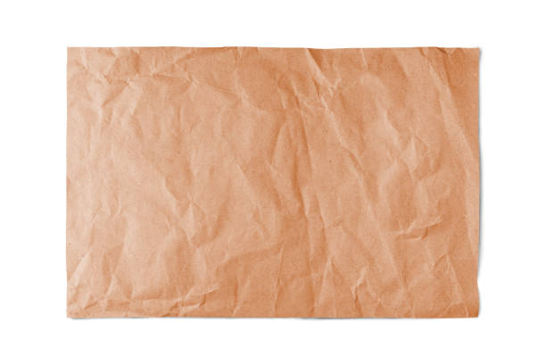 Cтоковое фото Оранжевый скомканный лист бумаги с изолированным краем на белом фоне.