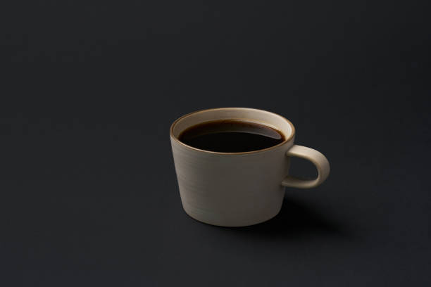 istock Black coffee and coffee beans on black background 1751705110