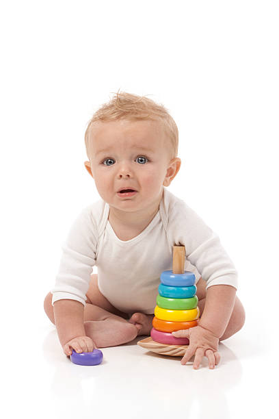 Baby Sitting Playing with Toys on White Background