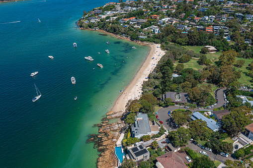 Panoramic drone aerial view over Cobblers Bay and Chinamans Beach in Mosman, Northern Beaches area of Sydney, Australia.