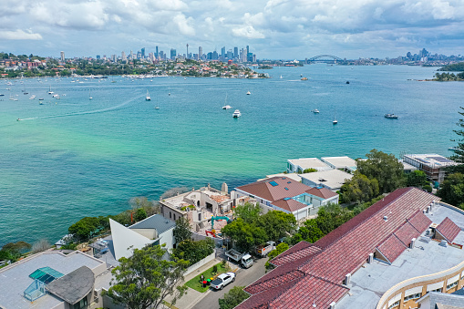 Drone aerial view of Rose Bay, eastern suburb of Sydney with Harbour Bridge and Opera House in the distance