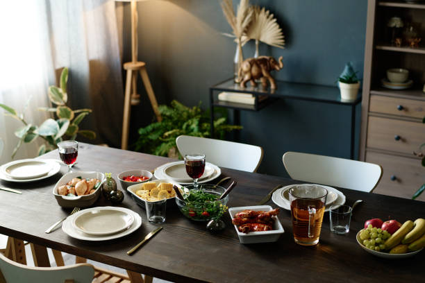 istock Wooden table with holiday dinner standing in spacious living room 1751708421