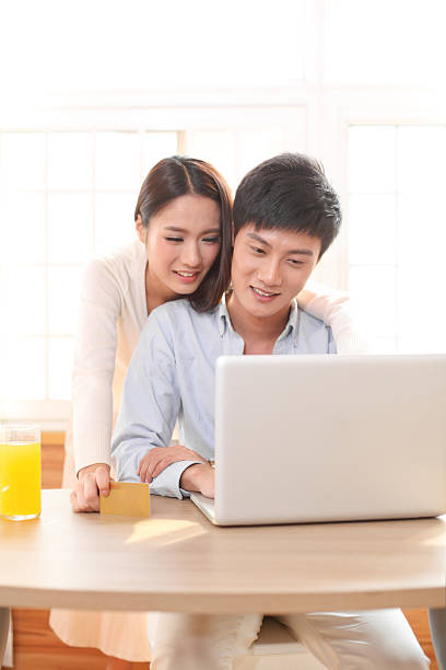 istock happy young couple using laptop at home 175171142