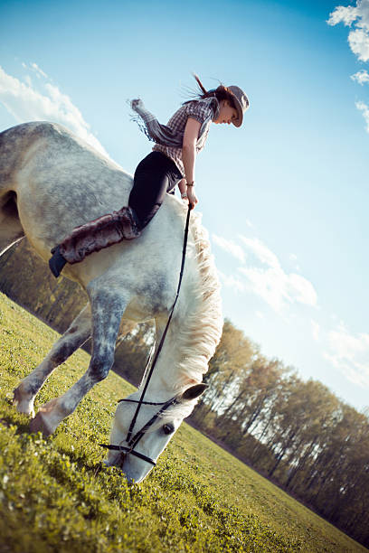 istock Young woman riding horse 175171163